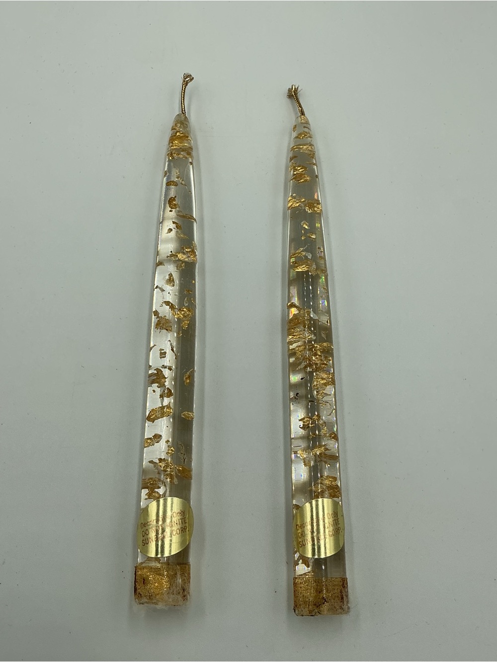 Vintage Lucite clear taper candles featuring embedded floating gold leaf flakes